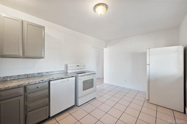 kitchen featuring white appliances, light tile patterned flooring, and gray cabinets