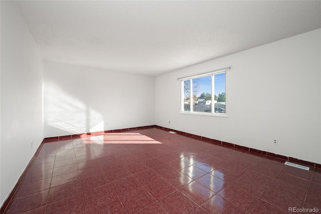 spare room with a textured ceiling