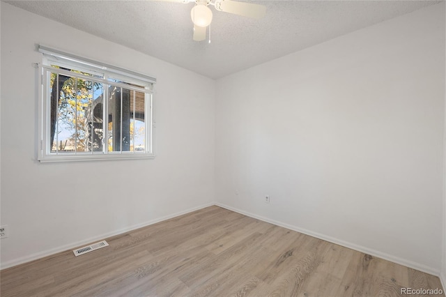 unfurnished room with light hardwood / wood-style flooring, a textured ceiling, and ceiling fan