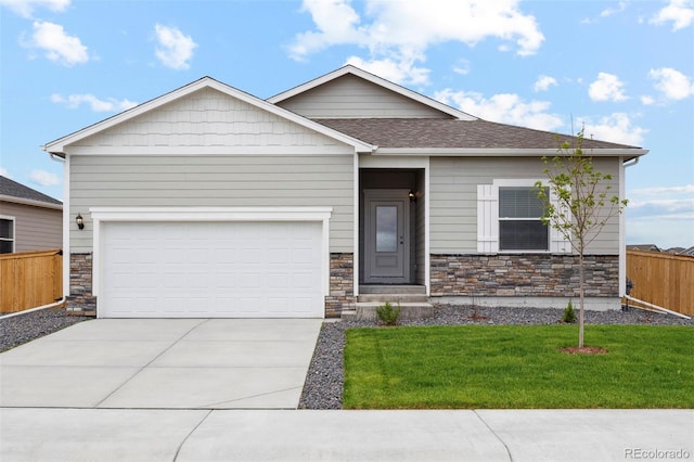 view of front of home featuring a garage and a front lawn