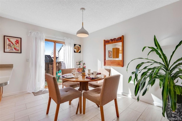 dining area featuring a textured ceiling