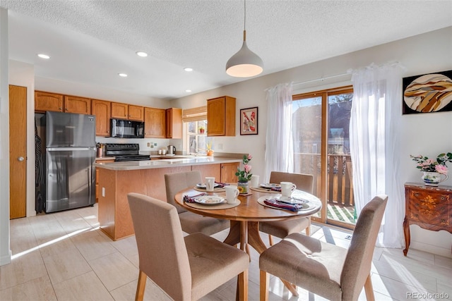 dining area with recessed lighting and a textured ceiling