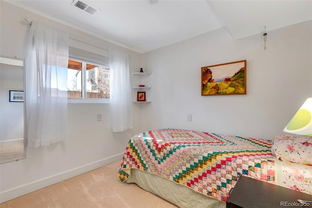 bedroom with carpet floors, visible vents, and baseboards