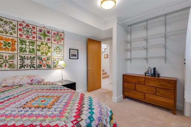 bedroom with light carpet and baseboards