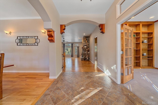 corridor with hardwood / wood-style flooring