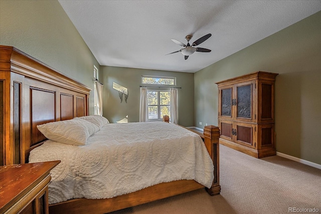 bedroom featuring ceiling fan, carpet flooring, and a textured ceiling