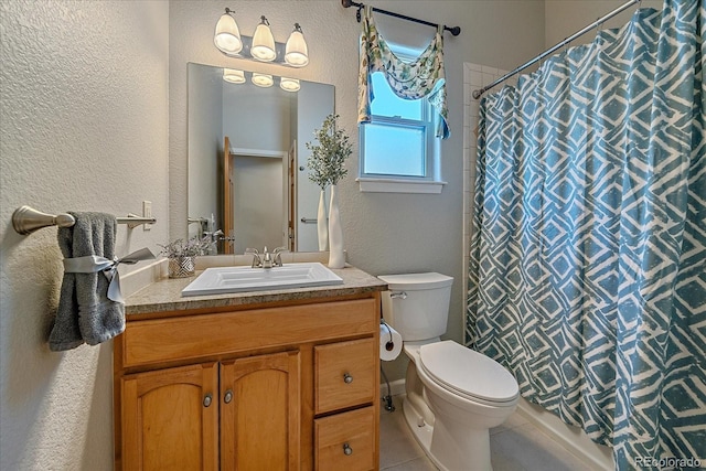 bathroom featuring vanity, tile patterned flooring, curtained shower, and toilet