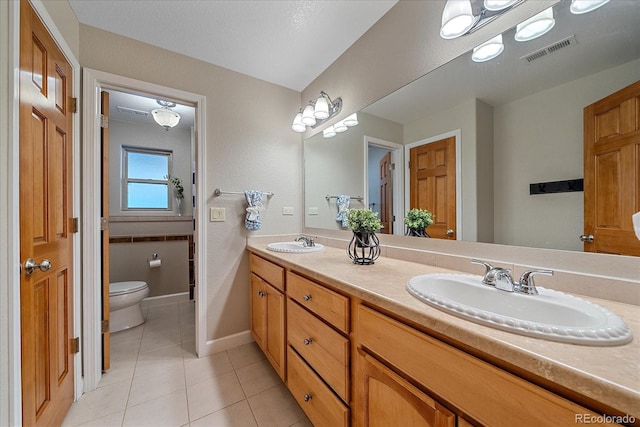 bathroom featuring tile patterned floors, toilet, and vanity