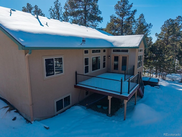 view of snow covered back of property