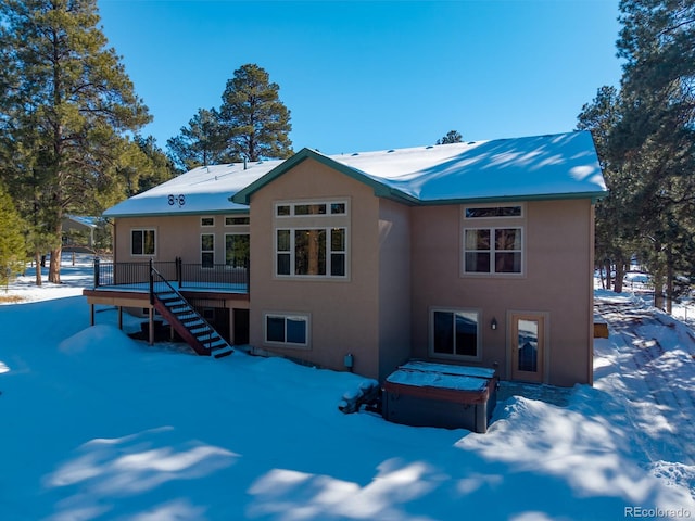 snow covered house with a deck