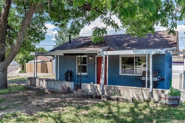 3151 N Elizabeth St, Denver, CO 80205 - view of front of home with roof with shingles, brick siding, and a porch