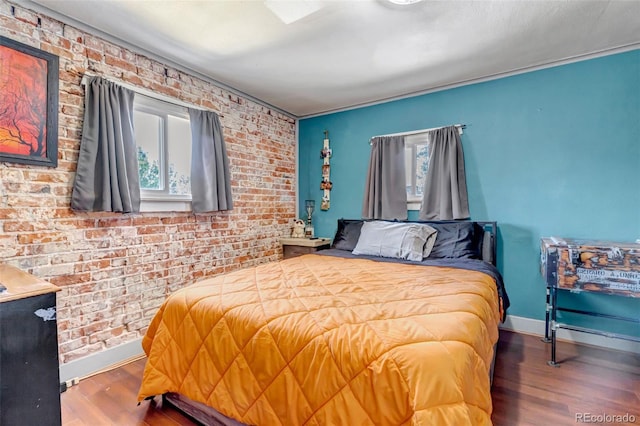 3151 N Elizabeth St, Denver, CO 80205 - bedroom with multiple windows, wood finished floors, and brick wall