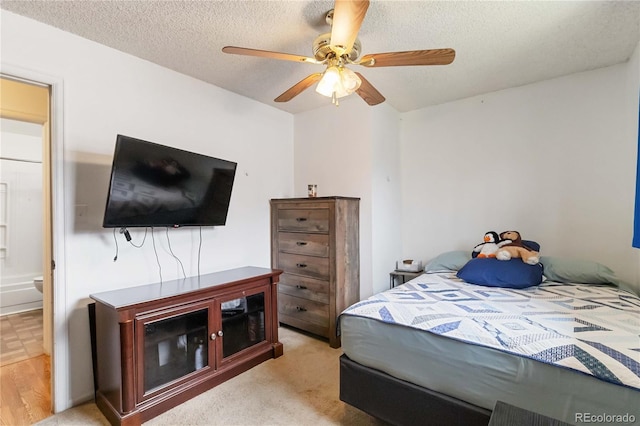 bedroom featuring a textured ceiling and a ceiling fan