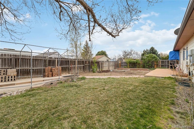view of yard featuring a patio area and a vegetable garden