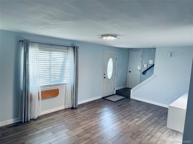 entryway featuring wood-type flooring and a textured ceiling