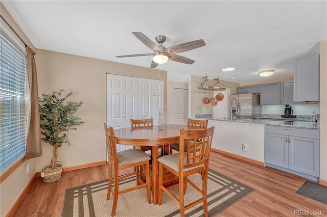 1786 Wintergreen Pl, Loveland, CO 80537 - dining room with light wood finished floors, baseboards, and a ceiling fan