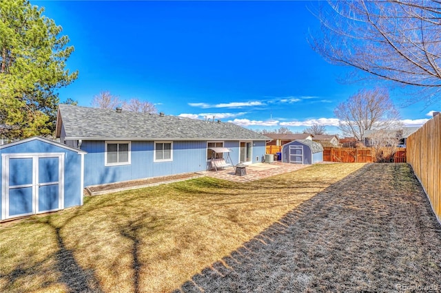 1786 Wintergreen Pl, Loveland, CO 80537 - back of house featuring a storage unit, a lawn, a patio area, a fenced backyard, and an outdoor structure