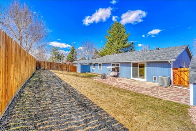 1786 Wintergreen Pl, Loveland, CO 80537 - back of property featuring a yard, an outdoor fire pit, a patio area, central AC, and a fenced backyard