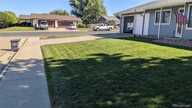 1786 Wintergreen Pl, Loveland, CO 80537 - view of yard featuring a garage and concrete driveway
