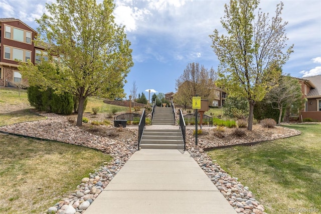 surrounding community with stairs and a yard