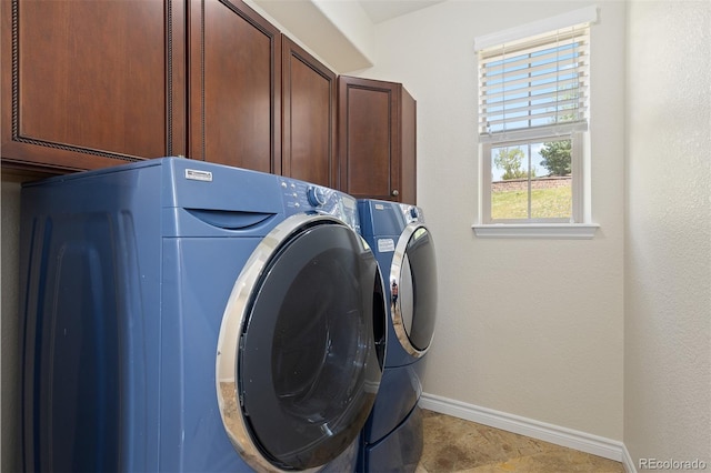laundry room with cabinet space, washing machine and clothes dryer, and baseboards