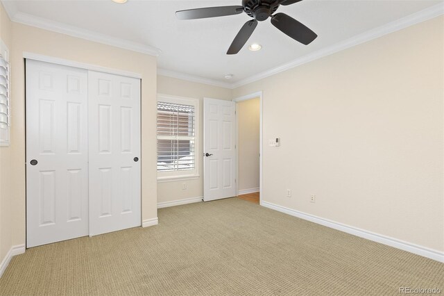 unfurnished bedroom featuring light carpet, a closet, baseboards, crown molding, and recessed lighting