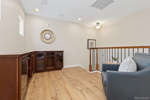 sitting room with light wood-style flooring, baseboards, and recessed lighting