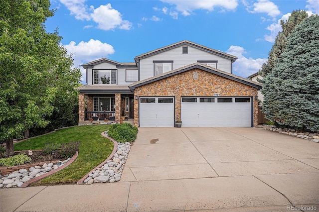 9249 Fox Fire Dr, Highlands Ranch, CO 80129 - view of front of property featuring an attached garage, concrete driveway, stone siding, and a front lawn