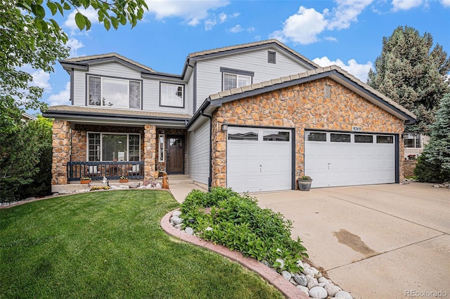 9249 Fox Fire Dr, Highlands Ranch, CO 80129 - view of front of home with stone siding, covered porch, driveway, and an attached garage