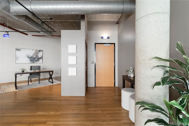 hallway with hardwood / wood-style flooring