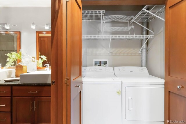 laundry room with separate washer and dryer and sink