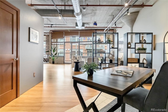1863 Wazee St Unit 6E, Denver, CO 80202 - dining room featuring wood finished floors, a towering ceiling, floor to ceiling windows, and track lighting
