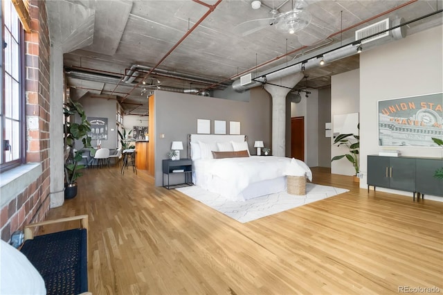 1863 Wazee St Unit 6E, Denver, CO 80202 - bedroom featuring wood finished floors and a towering ceiling
