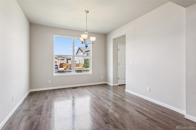 3823 Horiuchi St, Brighton, CO 80601 - empty room featuring a chandelier, wood finished floors, and baseboards
