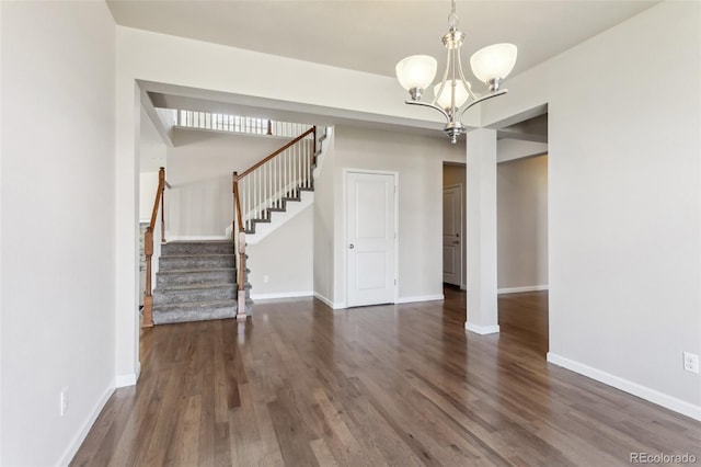 3823 Horiuchi St, Brighton, CO 80601 - unfurnished dining area featuring stairs, wood finished floors, a chandelier, and baseboards