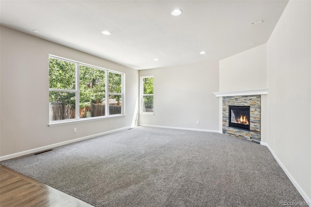 3823 Horiuchi St, Brighton, CO 80601 - unfurnished living room featuring baseboards, a fireplace, recessed lighting, and carpet flooring
