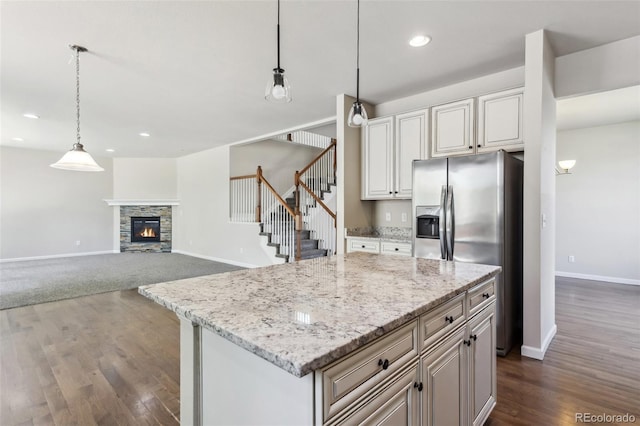 3823 Horiuchi St, Brighton, CO 80601 - kitchen with stainless steel refrigerator with ice dispenser, baseboards, dark wood finished floors, hanging light fixtures, and recessed lighting