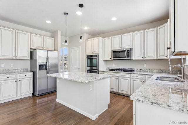 3823 Horiuchi St, Brighton, CO 80601 - kitchen featuring appliances with stainless steel finishes, a sink, dark wood-style flooring, light stone counters, and a center island