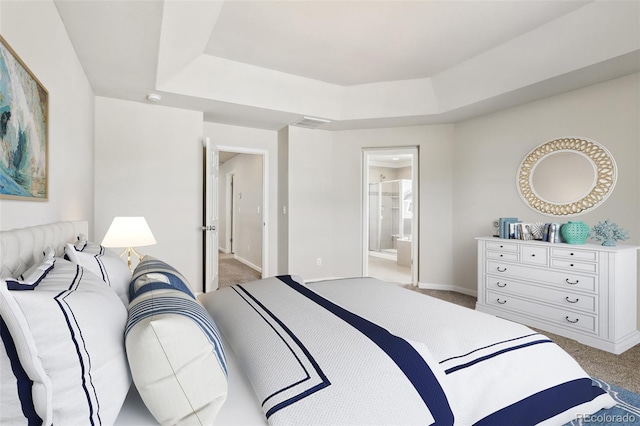 3823 Horiuchi St, Brighton, CO 80601 - bedroom featuring light colored carpet, a tray ceiling, baseboards, and ensuite bath