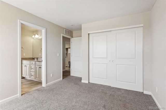 3823 Horiuchi St, Brighton, CO 80601 - unfurnished bedroom featuring light colored carpet, a closet, ensuite bathroom, baseboards, and a sink