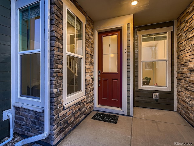 23545 E Platte Dr Unit C, Aurora, CO 80016 - doorway to property featuring covered porch and stone siding