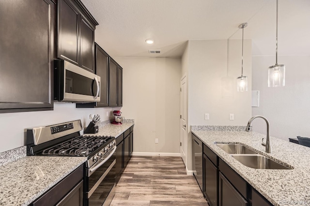 23545 E Platte Dr Unit C, Aurora, CO 80016 - kitchen featuring appliances with stainless steel finishes, a sink, light wood-type flooring, light stone counters, and recessed lighting