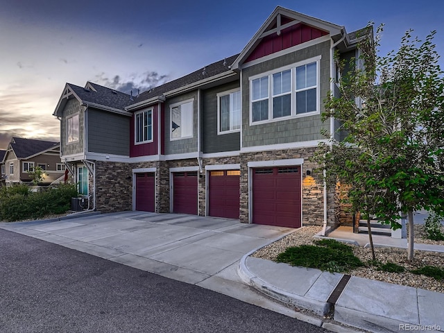 23545 E Platte Dr Unit C, Aurora, CO 80016 - view of front of property featuring a garage, stone siding, and driveway