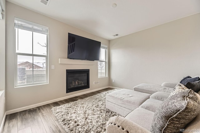 23545 E Platte Dr Unit C, Aurora, CO 80016 - living room featuring wood finished floors, baseboards, and a glass covered fireplace