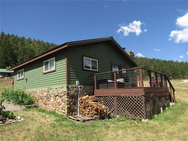 57920 US Highway 285 Unit 10, Bailey, CO 80421 - rear view of house with a wooden deck, a lawn, a forest view, and log veneer siding