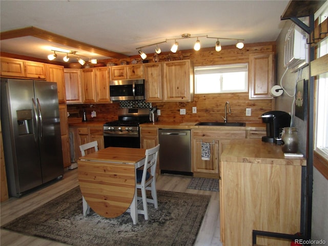 57920 US Highway 285 Unit 10, Bailey, CO 80421 - kitchen with stainless steel appliances, light wood-style floors, backsplash, wooden counters, and light brown cabinets