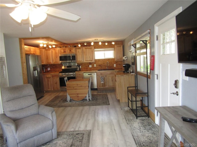 57920 US Highway 285 Unit 10, Bailey, CO 80421 - kitchen featuring appliances with stainless steel finishes, decorative backsplash, light wood-style flooring, ceiling fan, and open floor plan