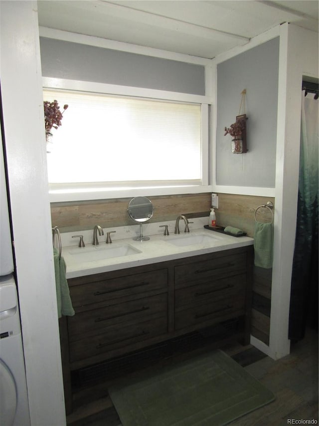 57920 US Highway 285 Unit 10, Bailey, CO 80421 - full bathroom with stacked washer and clothes dryer, wood finished floors, and double vanity