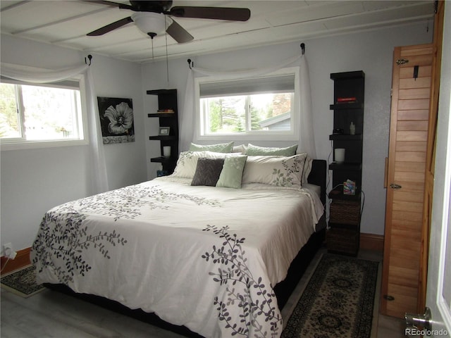 57920 US Highway 285 Unit 10, Bailey, CO 80421 - bedroom featuring multiple windows, wood finished floors, and ceiling fan