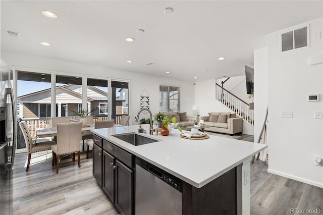 kitchen with visible vents, dishwasher, light wood-type flooring, a sink, and recessed lighting